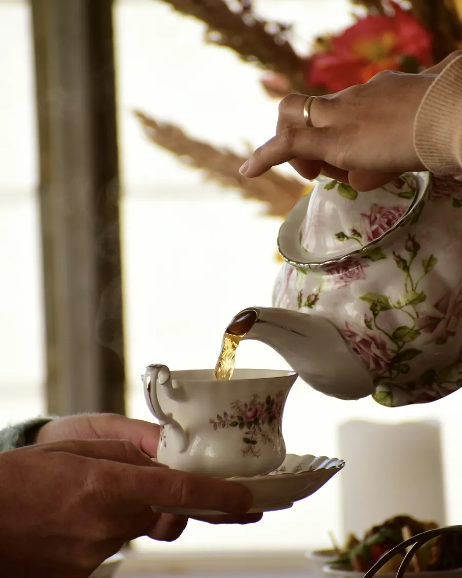 Tea being poured from a porcelain teapot